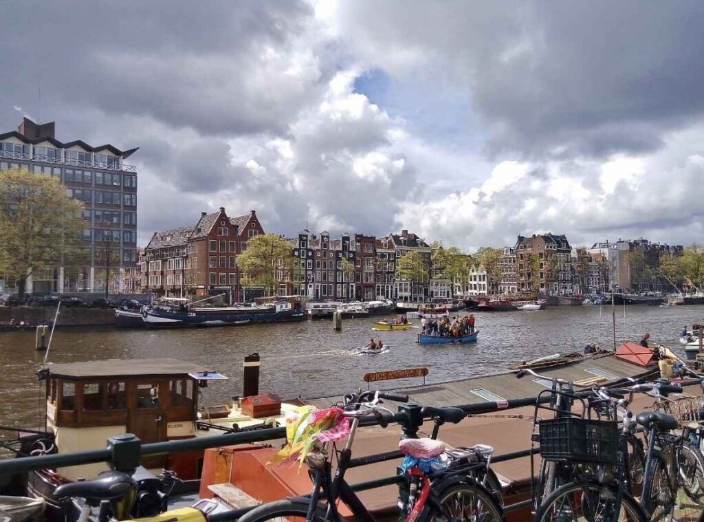 Scenic Amstel River path with benches and calm water views