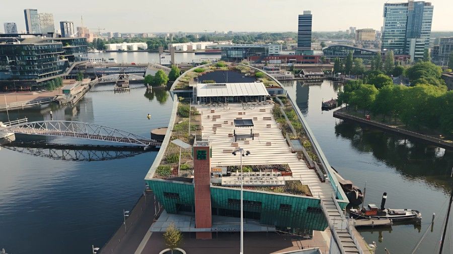 Panoramic view of Amsterdam from NEMO rooftop terrace with seating